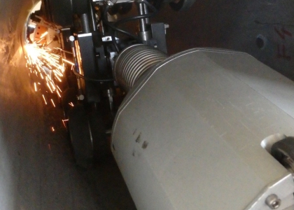 Grinding robot removes a cable-channel conduit's root overhangs
